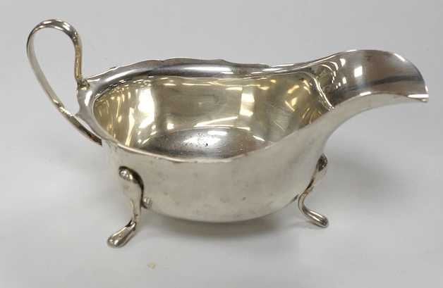 Two George V silver sauceboats and two cased flatware sets. Condition - fair